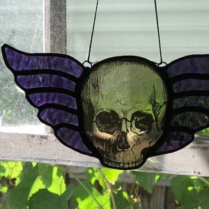 Grey skull with purple iridescent wings